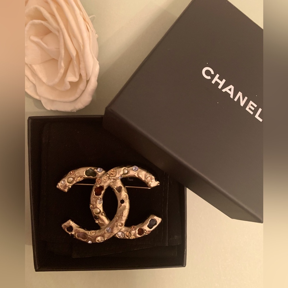 Chanel Gold Brooch with multiple colorful stones.